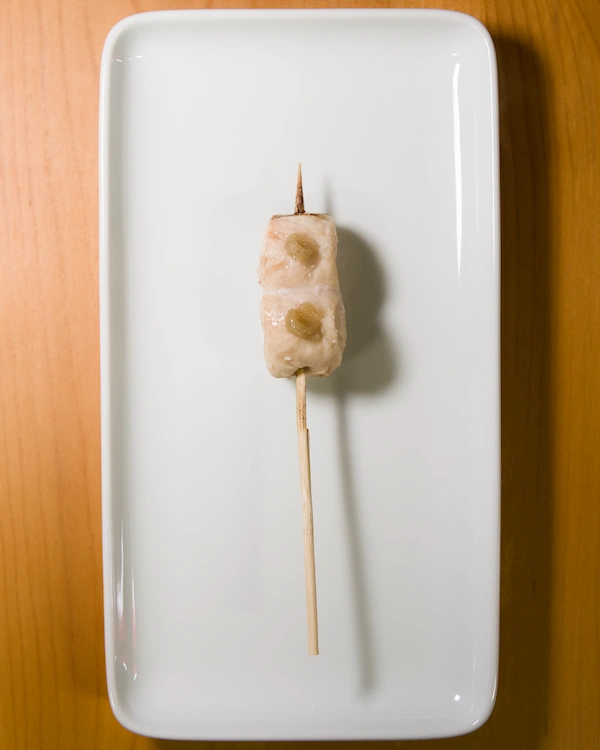 A yakitori skewer with chicken tender and wasabi on top