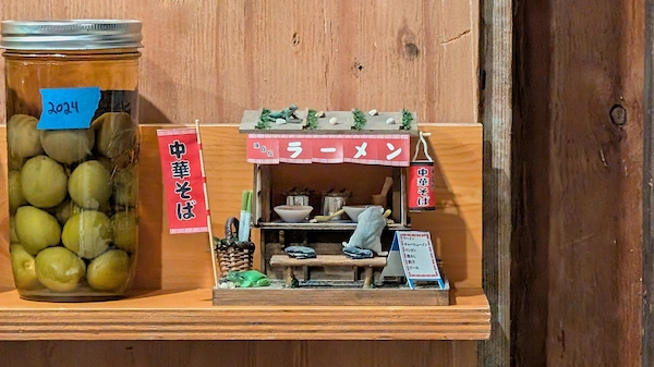 Ramen shop diorama next to a jar of umeshu