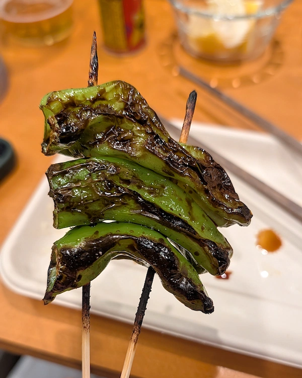 Grilled shishito pepper skewer